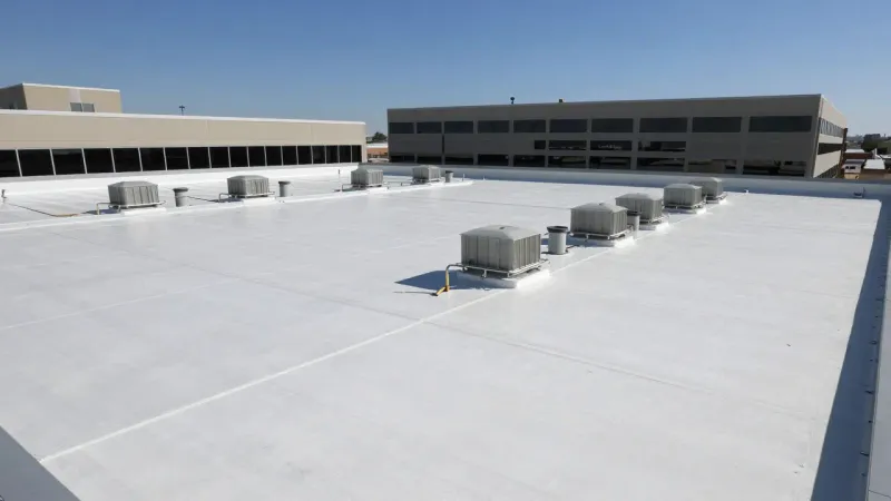 Completed commercial roofing installation on a low-slope office building in Lehi Utah with clean TPO membrane and natural daylight