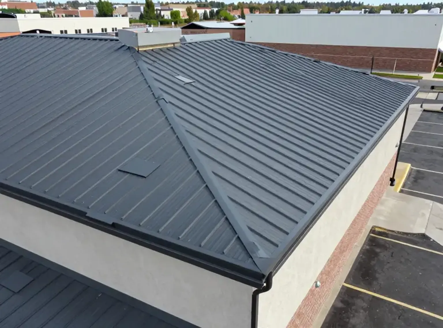 Documentary-style iPhone photo of TPO roofing membrane installation on a Lehi Utah commercial building with natural lighting