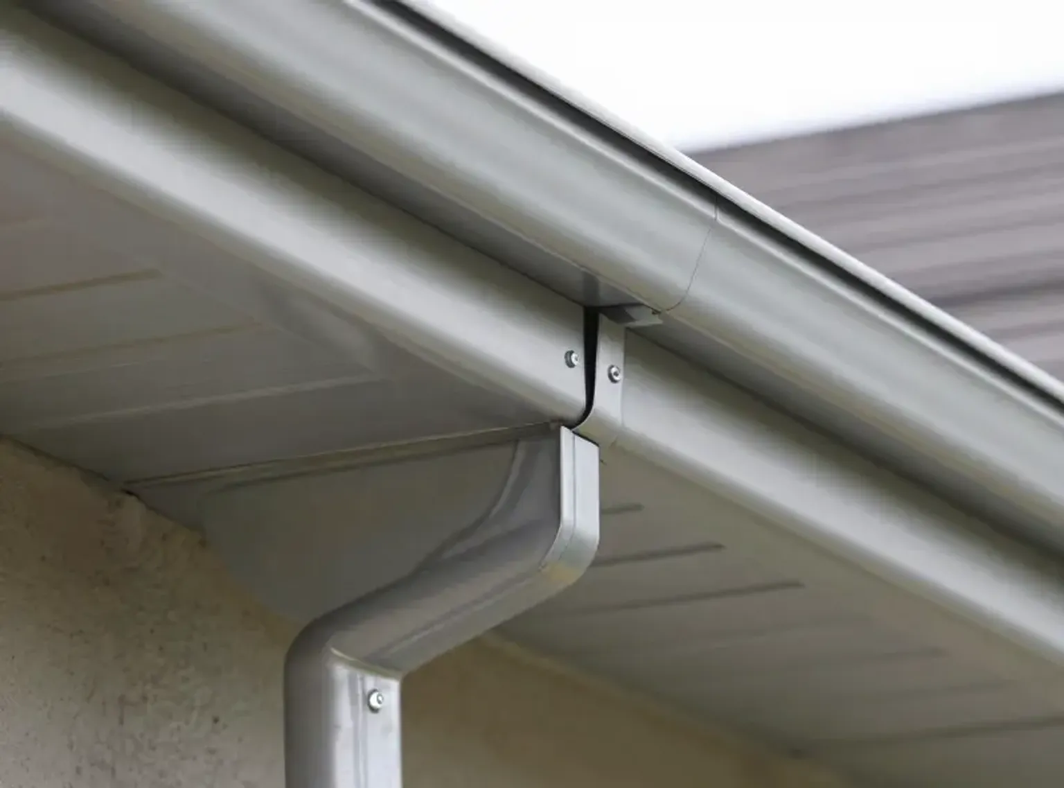 Documentary-style iPhone photo of completed gutter repair on a Lehi Utah residential home showing clean repaired sections with proper slope