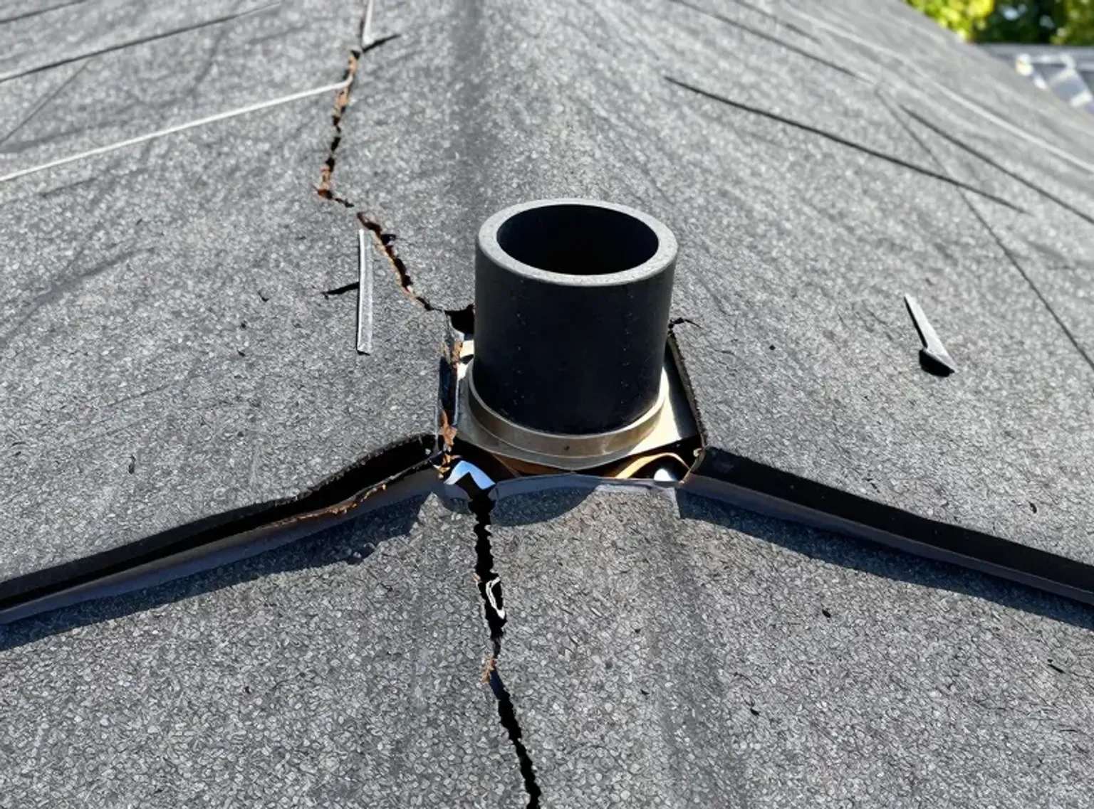 Documentary-style iPhone photo of roof inspector reviewing shingle granule condition on a Lehi Utah home with natural lighting