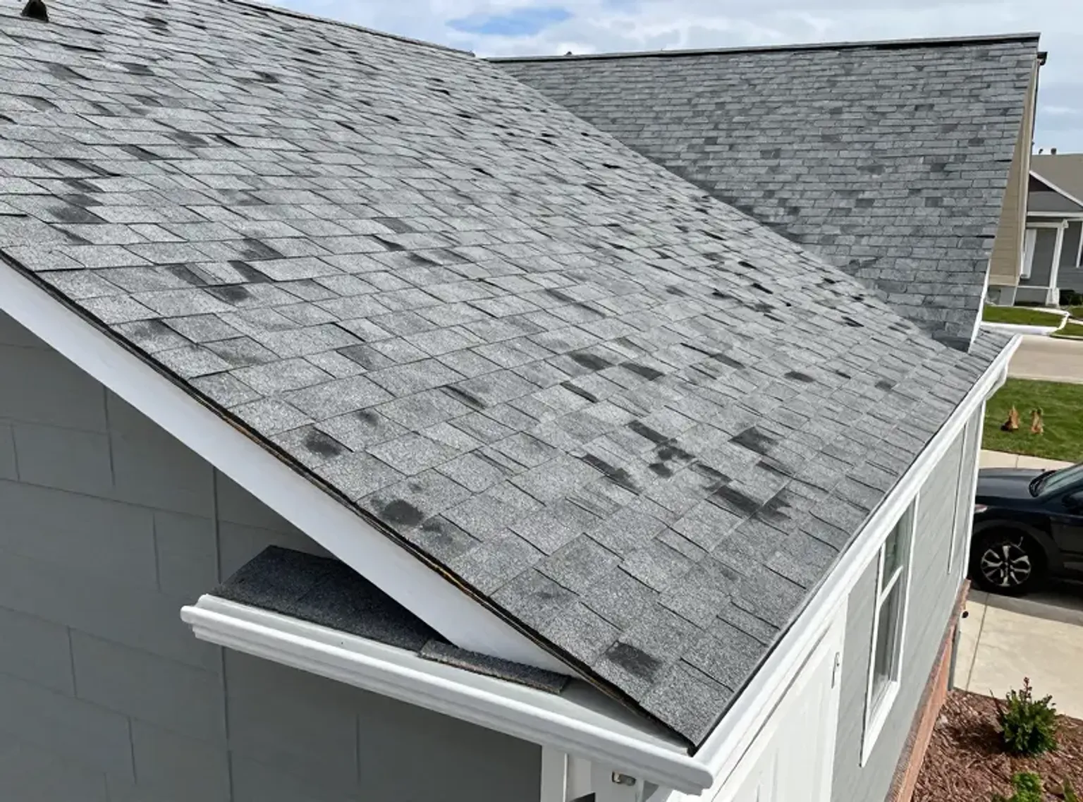 Documentary-style iPhone close-up of sealant refreshing around a pipe penetration during roof maintenance on a Lehi Utah residential home