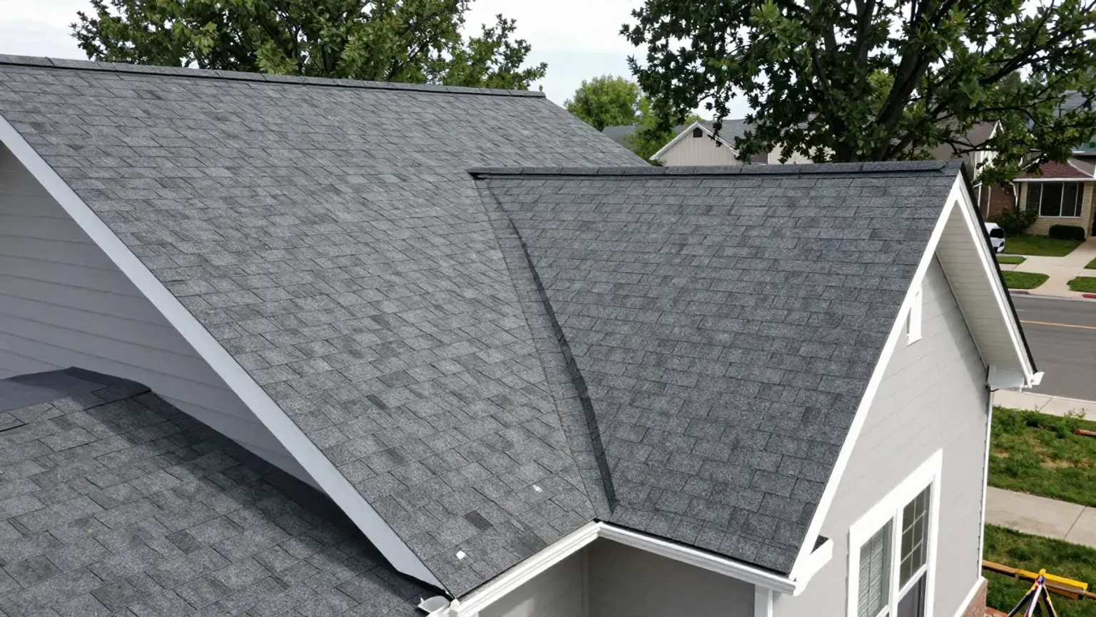 Professional roofing contractors working on a residential roof in Lehi, Utah