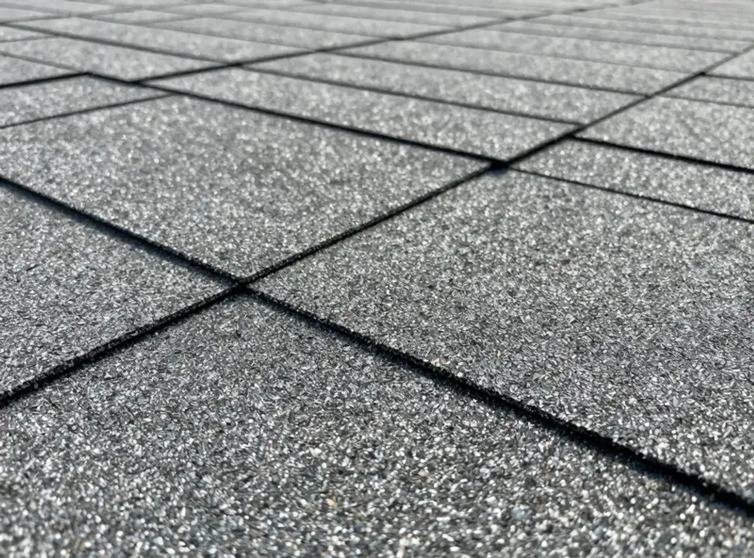 Documentary-style iPhone photo of completed shingle replacement on a Lehi Utah residential home showing clean finished surface and ridge cap